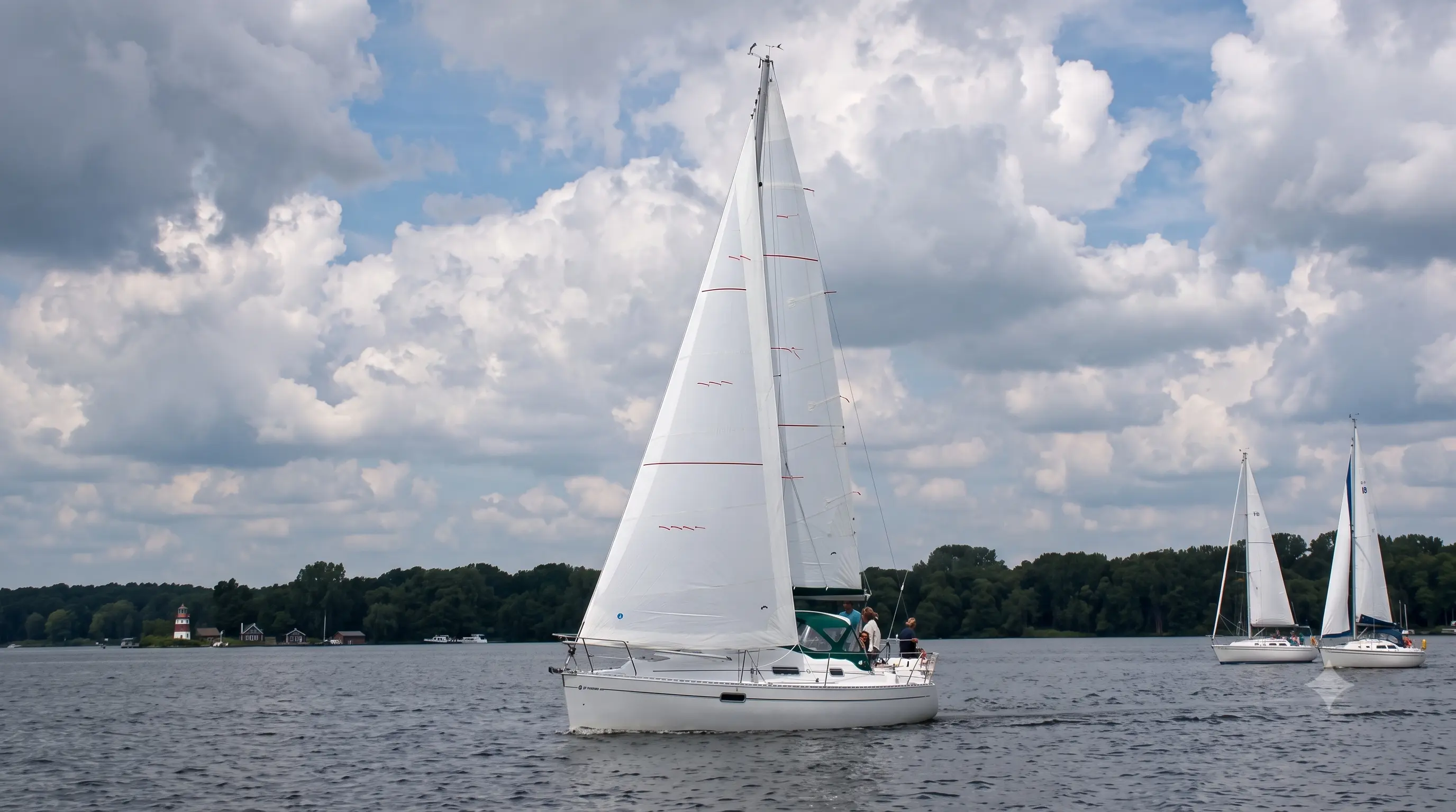 White headsail drawing a cruising yacht across open water
