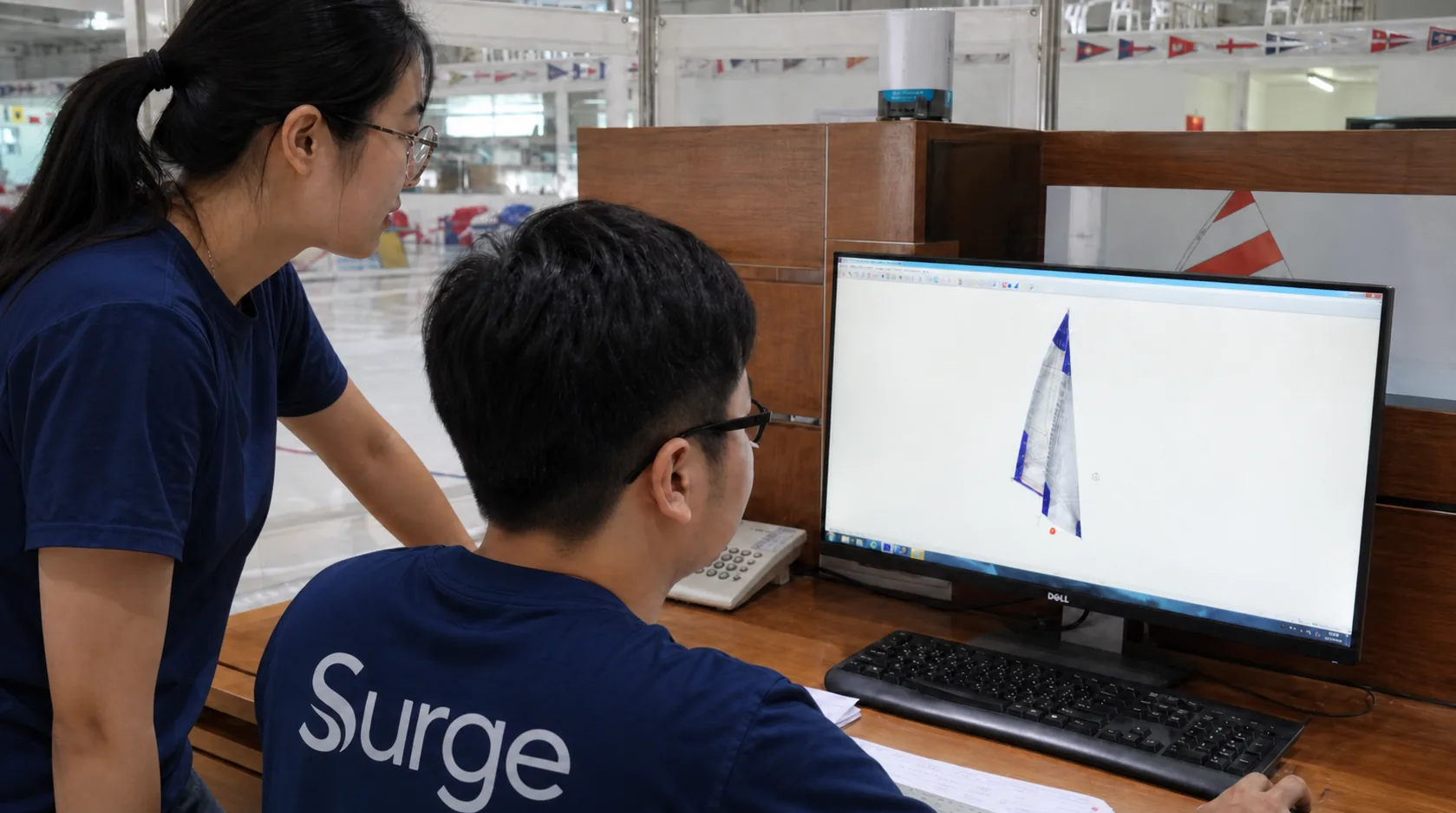 Surge sailmakers reviewing a sail design together