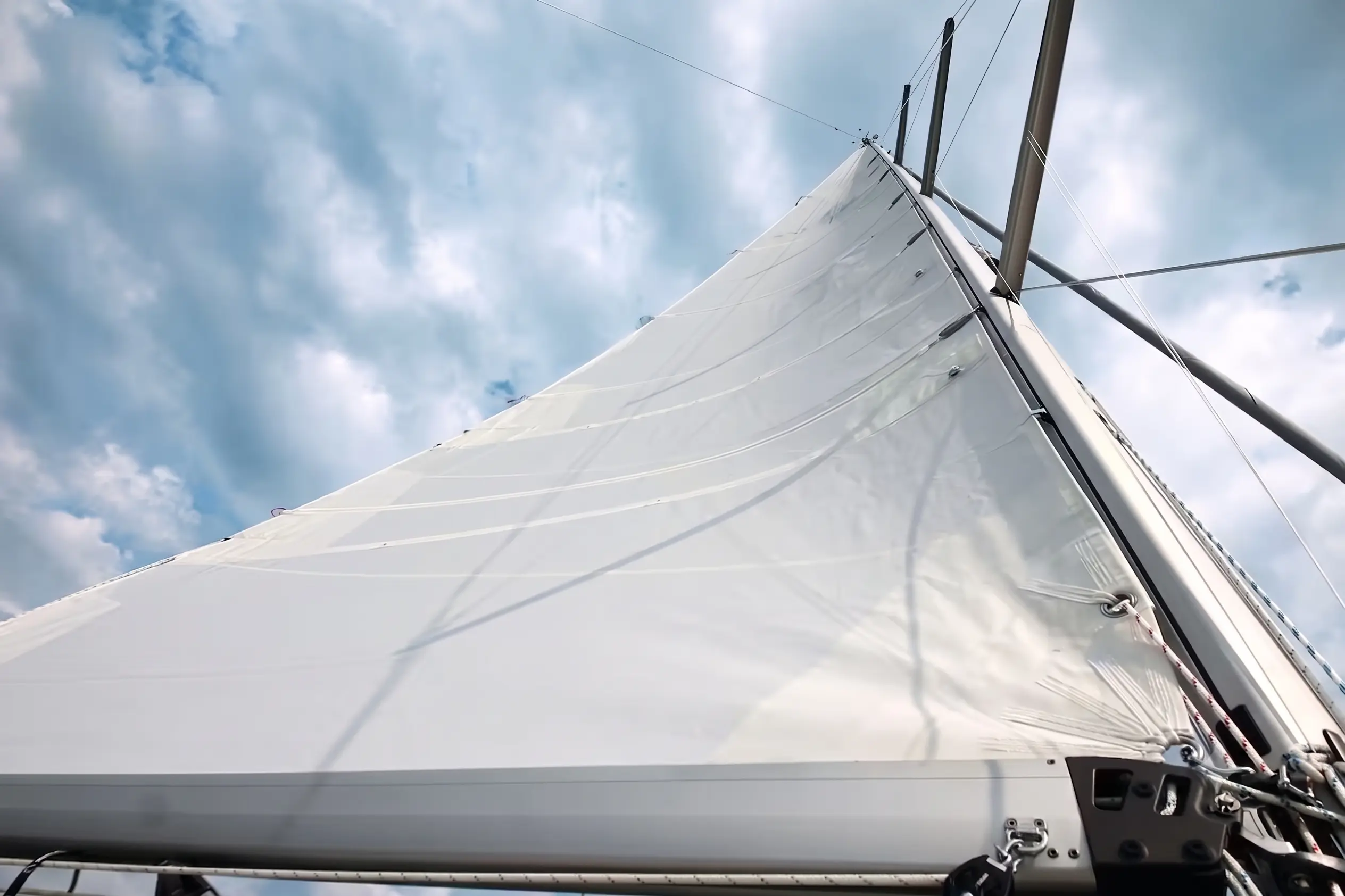 Close view looking up a white mainsail
